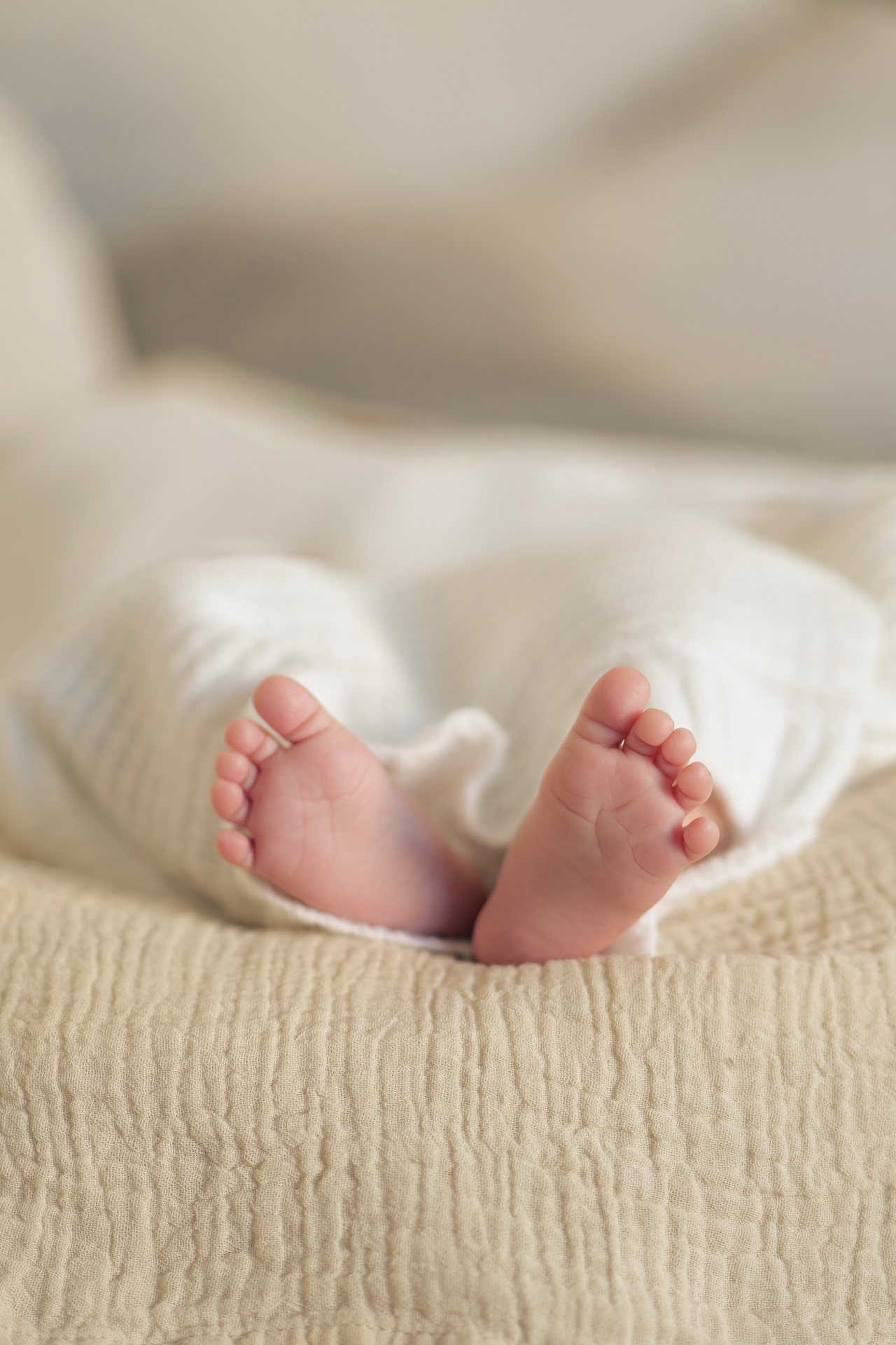 Newborn feet on soft linen