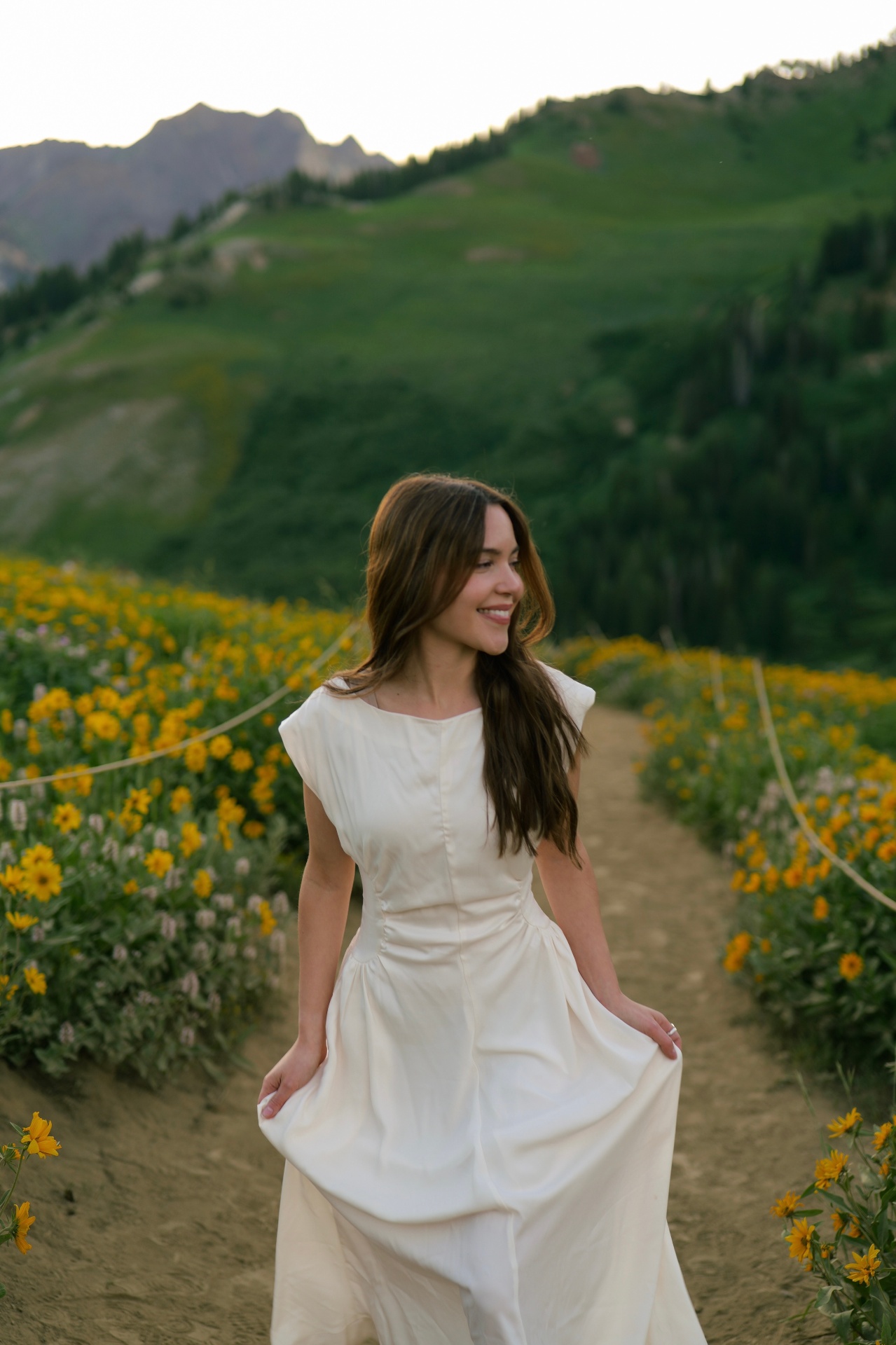 Photographer walking a wildflower path in the mountains