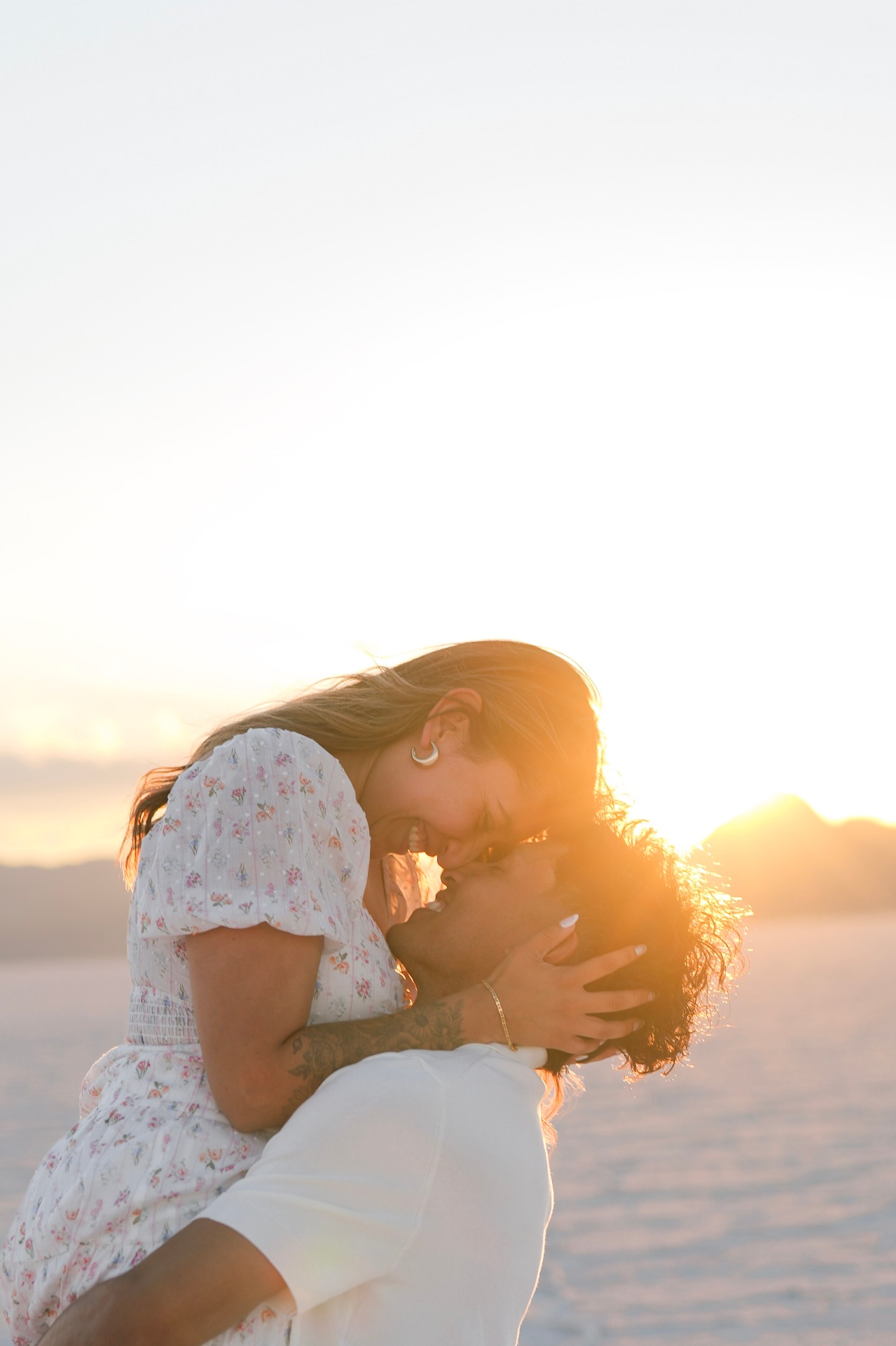 Couple kissing at sunset on the salt flats
