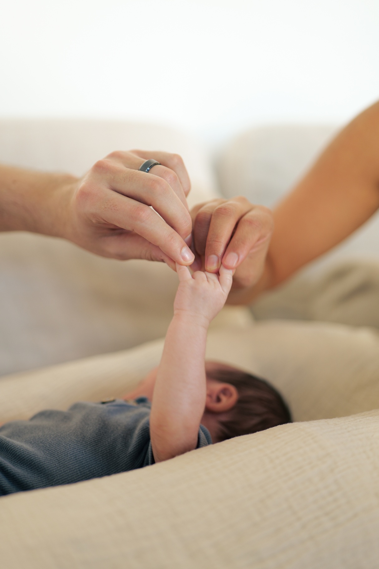 Parents holding their newborn's tiny hand