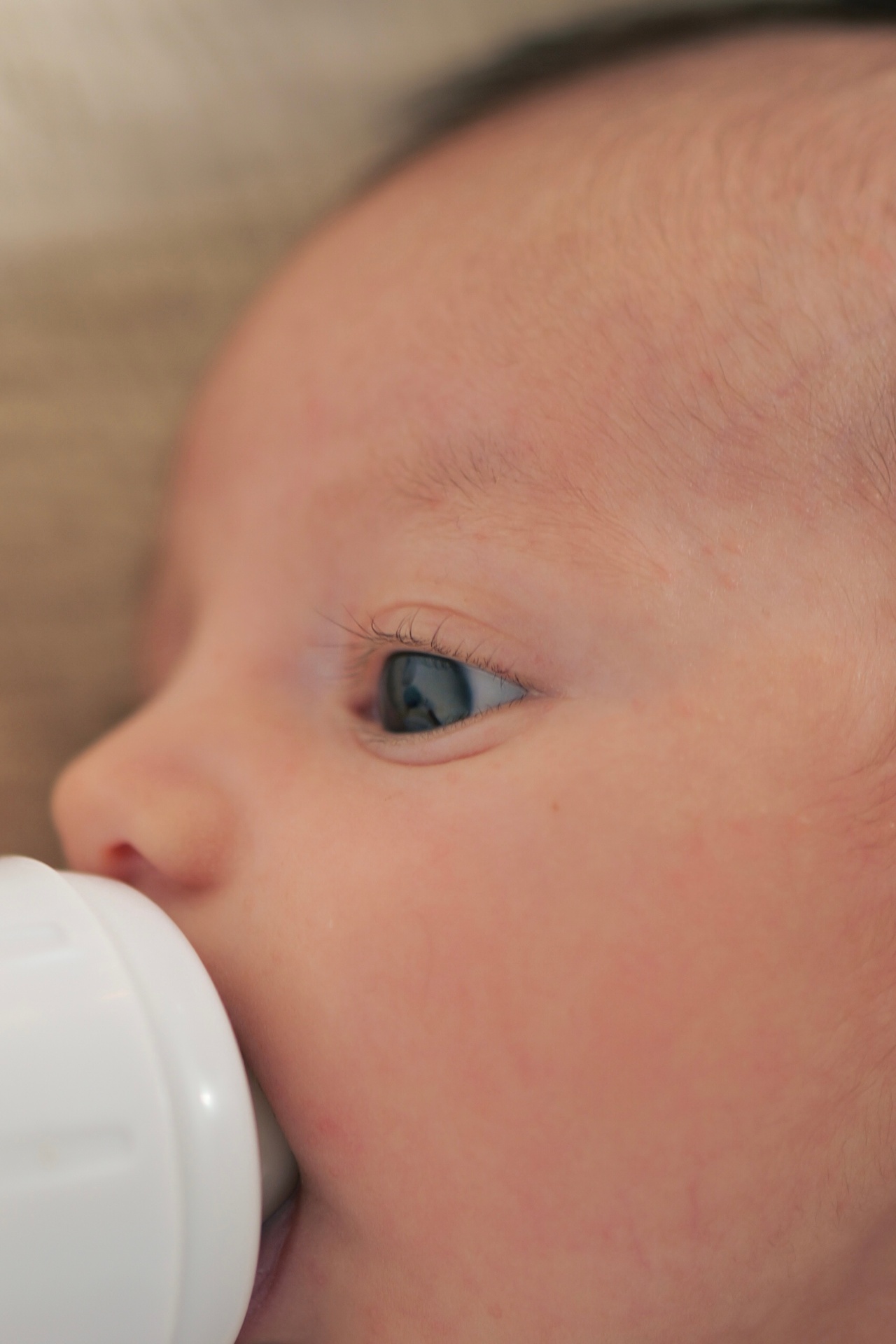 Close-up of a newborn's face during a feeding