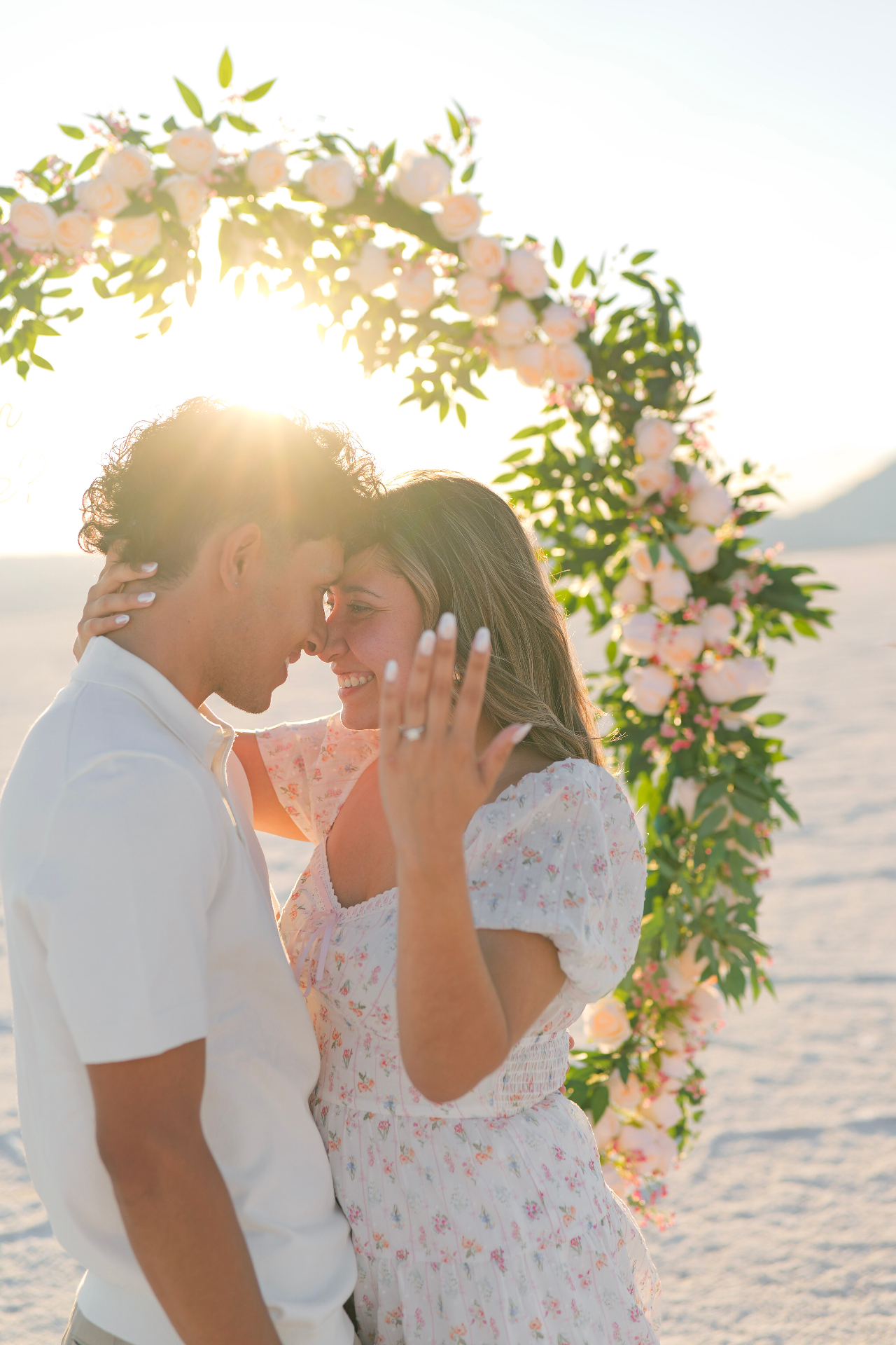 Proposal beneath a floral arch on the salt flats